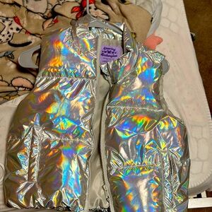 Hi my name is riona and I’m selling the metallic silver sleeveless coat